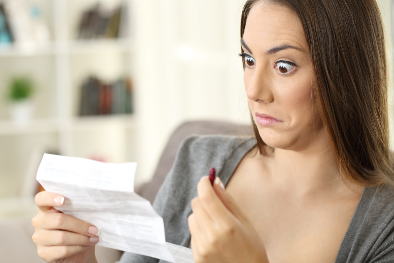 Woman looking shocked at patient information leaflet